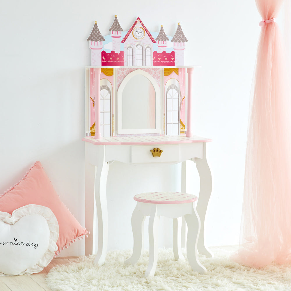 A pink and white Fantasy Fields Kids Dreamland Castle vanity set with a stool.