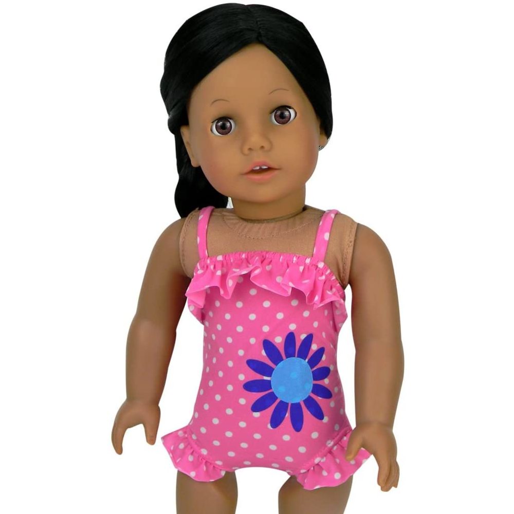 An 18" doll with brunette hair and brown eyes is wearing a pink ruffled polka dot bathing suit.